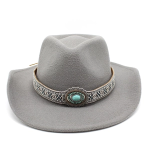 Macro detail of western cowboy hat featuring ethnic band and turquoise gemstone ornament