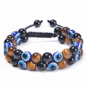 Détail du bracelet tressé à double couche avec perles d'oeil de tigre et mauvais oeil
