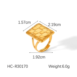 Detail of 18k gold plated stainless steel ring with textured square surface and open band