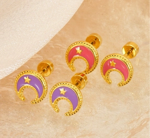 Macro detail of 18k gold plated moon and star stud earrings with purple enamel filling