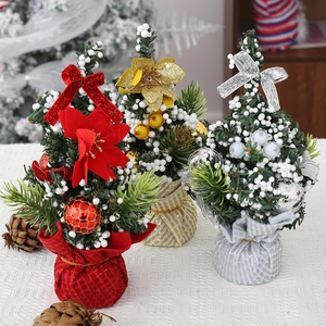 Set of three mini Christmas trees with festive flowers and ornaments for table decor