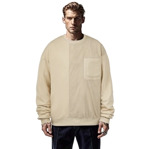 Detail of knit long sleeve sweatshirt showing vertical ribbed texture and chest pocket