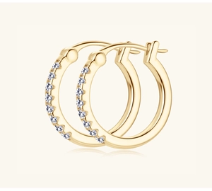 Close-up of golden moissanite hoop earrings with sparkling white zircon stone inlay