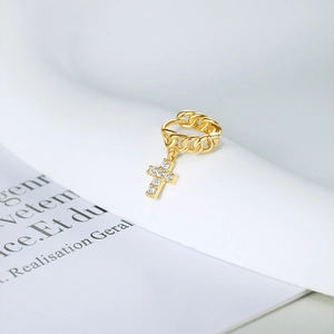 Close-up of gold cross earrings with micro-paved cubic zirconia on a chain drop