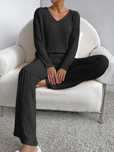Detail of black ribbed knit lounge set featuring a V-neck top and wide-leg trousers