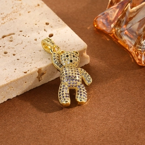 Detailed view of hip hop teddy bear pendant with purple and clear crystals on beige stone