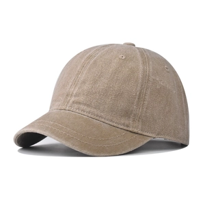 Detail shot of vintage washed khaki short brim baseball cap showing heavy cotton canvas texture