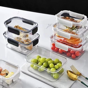 Stackable plastic food containers with airtight lids on a marble countertop for meal prep