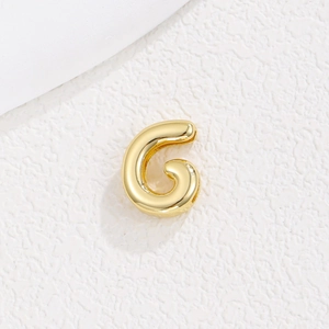 Detailed view of a 10mm gold-plated alphabet 'G' charm for DIY bracelet wristbands
