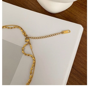 Detail of 18K gold-plated double-layer necklace with oval beads and adjustable clasp