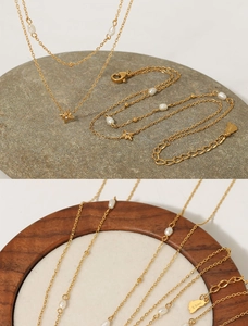 Double-layered gold stainless steel necklace with white pearl and star pendants