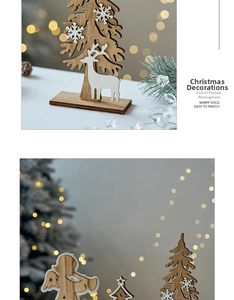 Detail of wooden Christmas tree and reindeer tabletop ornaments with warm gold lighting