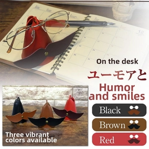 Detail of creative mustache-shaped leather glasses holders in black, brown and red