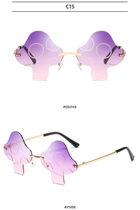 Detail view of mushroom-shaped rimless sunglasses with purple gradient lenses and gold frames