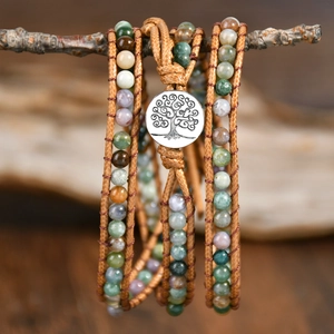 Macro shot of handmade Indian agate bead bracelet with Tree of Life charm on a branch