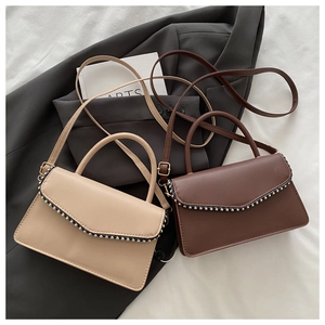 Detailed top view of beige and brown PU leather crossbody bags with silver beaded trim