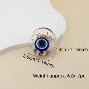 Close-up of blue Evil Eye hair claw clip with size measurements 3cm by 2.9cm