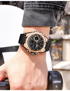 Close-up of dual-display sports watch with gold case and black silicone strap on wrist