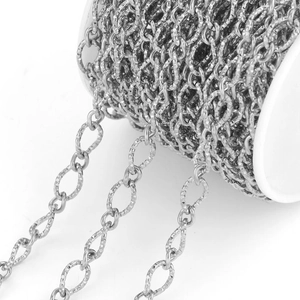 Macro detail of textured stainless steel oval link chain with hammered silver finish for DIY