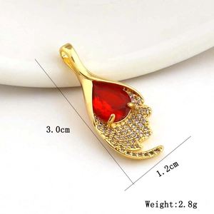 Macro detail of red teardrop zircon pendant showing 3.0cm length and 1.2cm width