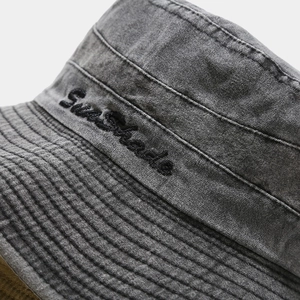 Detail of SunShade embroidery on charcoal grey washed cotton outdoor sun hat