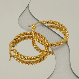 Golden stainless steel twisted hoop earrings with elegant rope texture on mirror surface