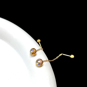 Close-up of gold chain earrings with rainbow moonstone and ball screw-back on a display