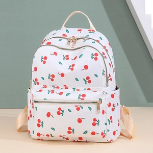 Lightweight white backpack with red cherry print and multiple zipper pockets for travel