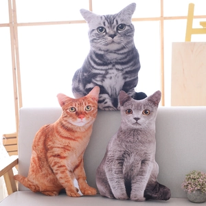 3D realistic cat plush pillows in grey and orange tabby designs on a grey sofa