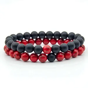 Detail of red marble and black matte beaded bracelets set with elastic string design