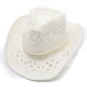 Close-up of white crochet cowboy hat featuring hollow mesh patterns and pearl band details
