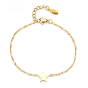 Detail of gold chain bracelet with pink enamel beads and a minimalist star pendant