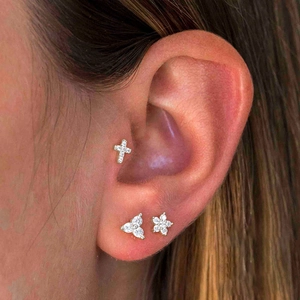 Silver zircon stud set with cross and floral designs for multi-piercing style