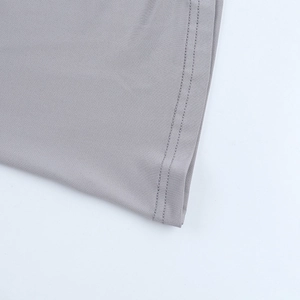 Detailed close-up of grey knitted fabric texture and double-stitched seam on a slim maxi dress