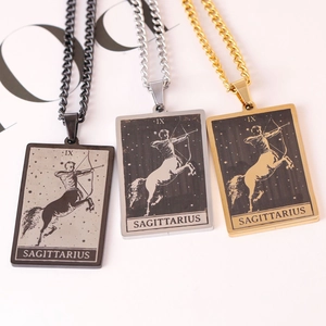 Detailed shot of Sagittarius tarot pendants in black, silver, and gold stainless steel