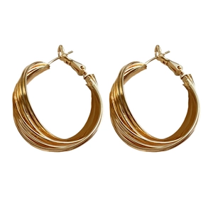 Elegant gold twisted hoop earrings with a minimalist circular design and shiny metallic finish