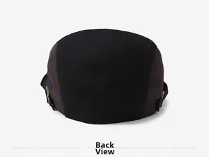 Back view of two-tone cotton beret cap with metal buckle and skull rivet details