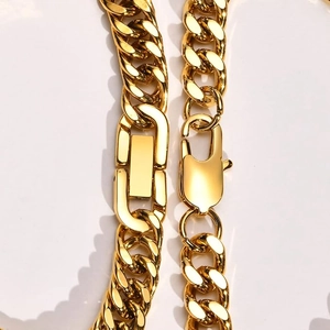 Polished gold double-woven Cuban link bracelet with lobster clasp on white background