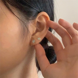 Minimalist 925 sterling silver smiley face and flower stud earrings set on ear model