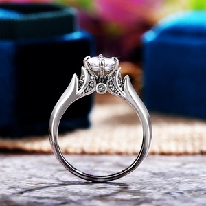 Macro shot of silver ring featuring six-prong set round zircon and crown hollow band design