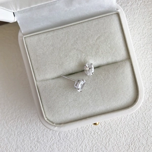 Close-up of S925 sterling silver stud earrings with oval-cut 5A zircon in a jewelry box
