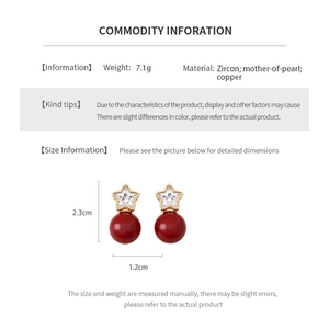 Detailed size view of star shaped zircon earrings with red pearl pendants in gold plating