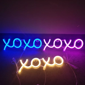 Neon LED XOXO sign lights in blue, pink, and warm yellow colors for wall decor
