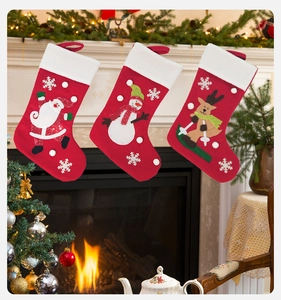 Three felt Christmas stockings with Santa, snowman and elk characters on a fireplace background