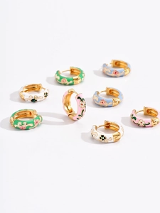 Detailed macro of vintage enamel flower hoop earrings in multiple pastel colors