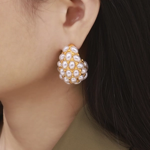 Vintage water-drop pearl earrings set in 18k gold plated titanium on model
