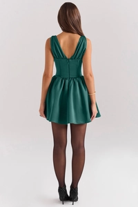Detailed back view of a forest green satin mini dress with deep V-neck and zipper