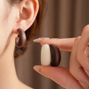 Minimalist wooden C-shaped hoop earrings in dark brown and creamy white vintage style