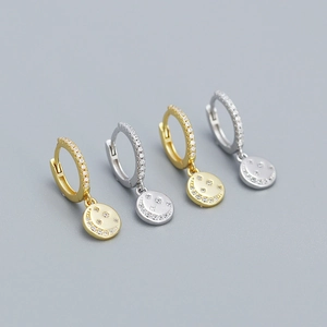 Detail view of 925 sterling silver star and moon hoop earrings in gold and silver finish