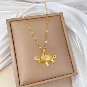 Elegant gold elephant necklace with sparkling crystals and blue gemstone eyes on silk